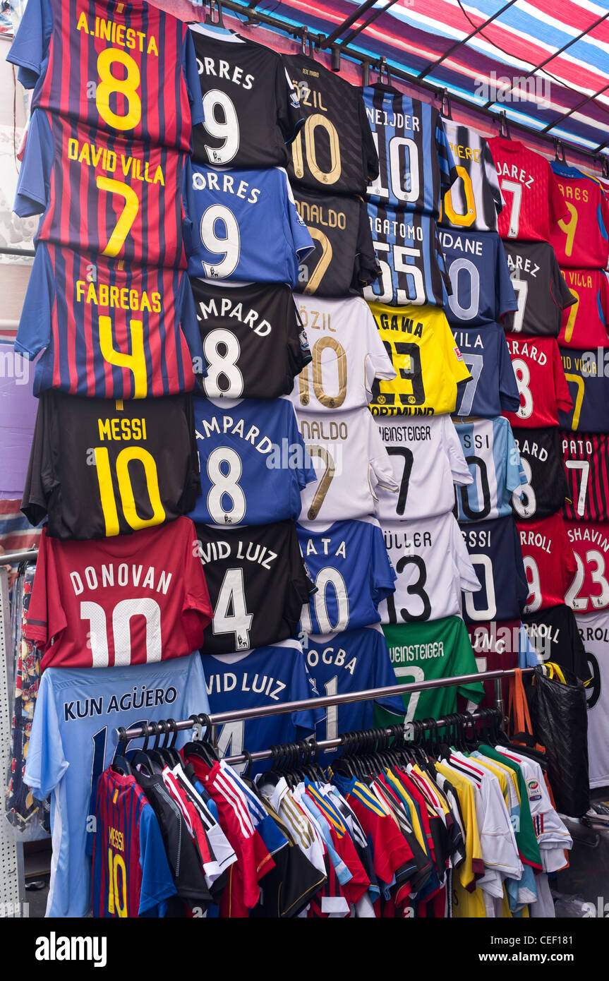 dh  MONG KOK HONG KONG Football shirt strips counterfeit soccer asia market chinese fake shirts china goods sale stall clothes forgery merchandise Stock Photo