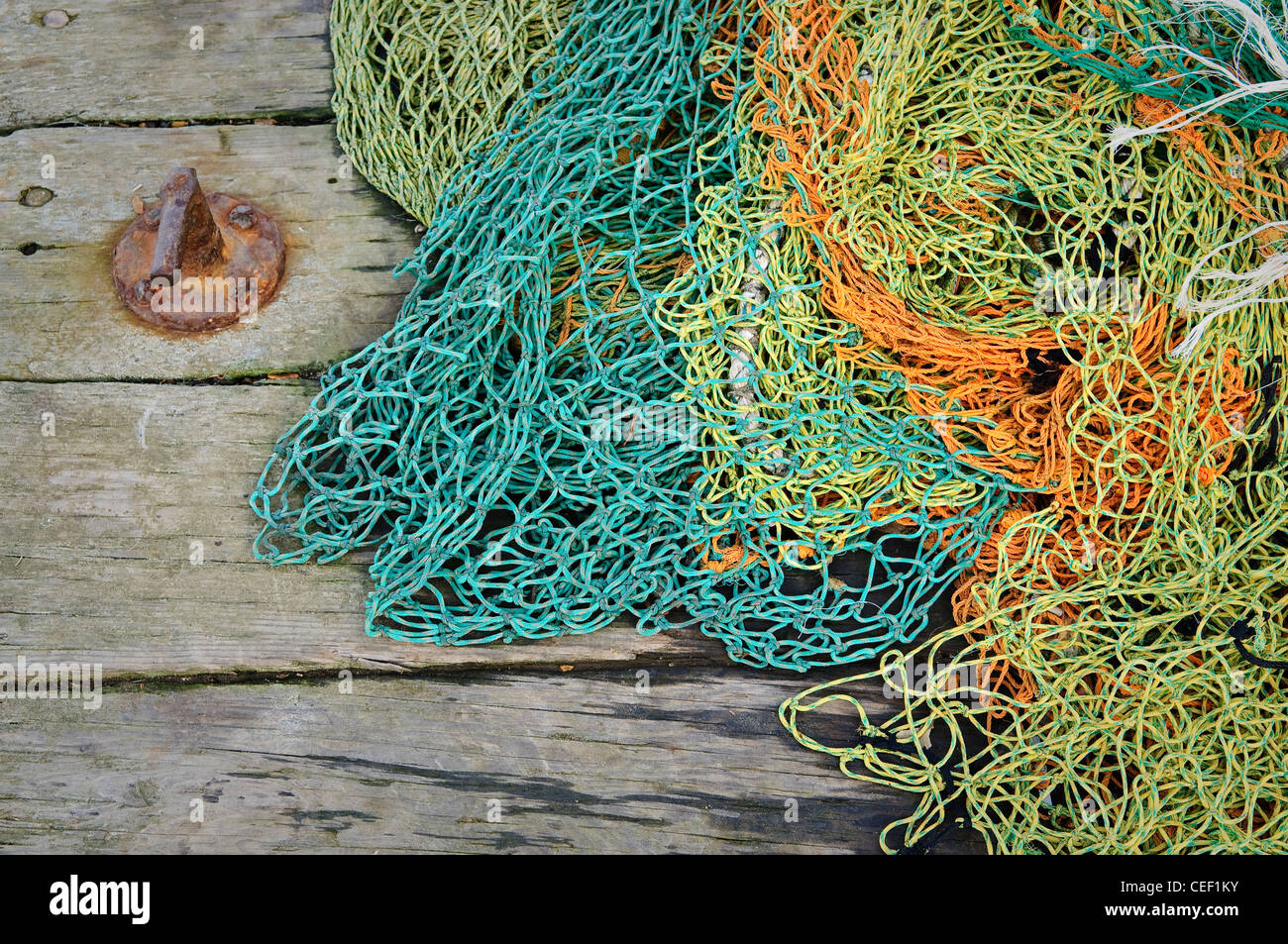 Tangled fishing nets on the old wooden pier. Stock Photo