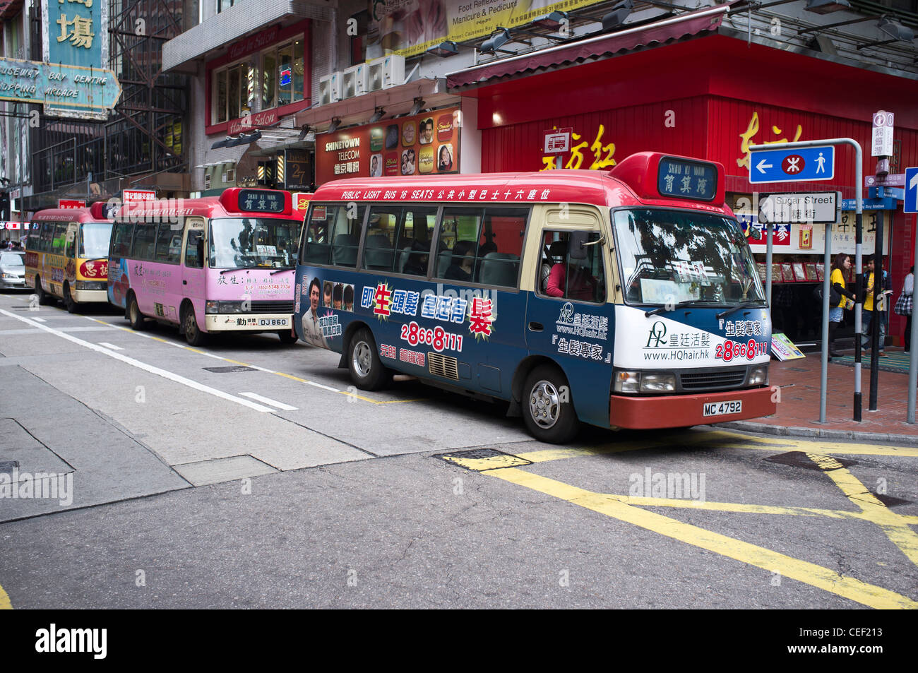 dh Public light buses CAUSEWAY BAY HONG KONG Red minibus with chinese calligraphy adverts mini bus asian transport island Stock Photo