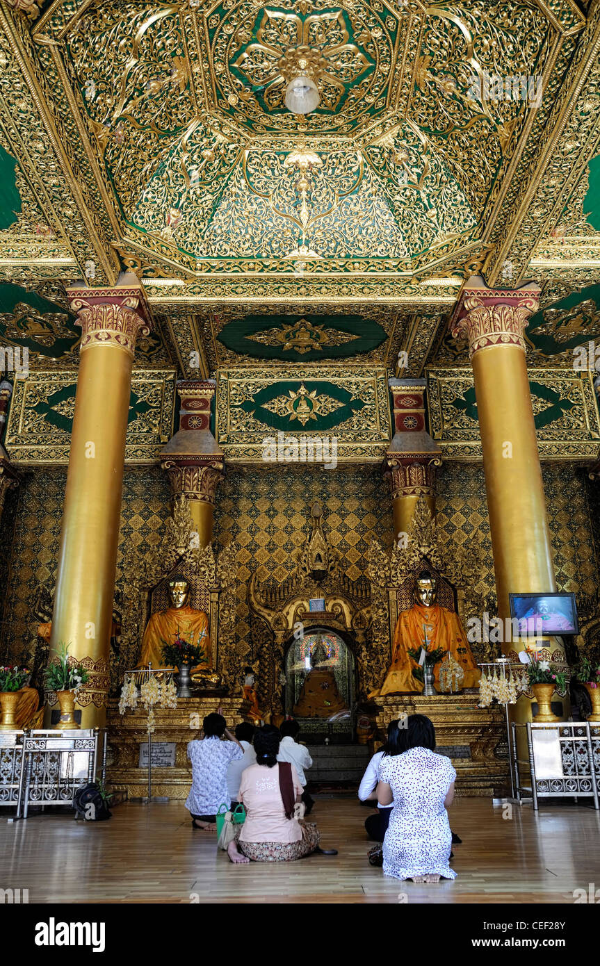 devotees pray praying worship buddha buddhist shrine buddhism Shwedagon