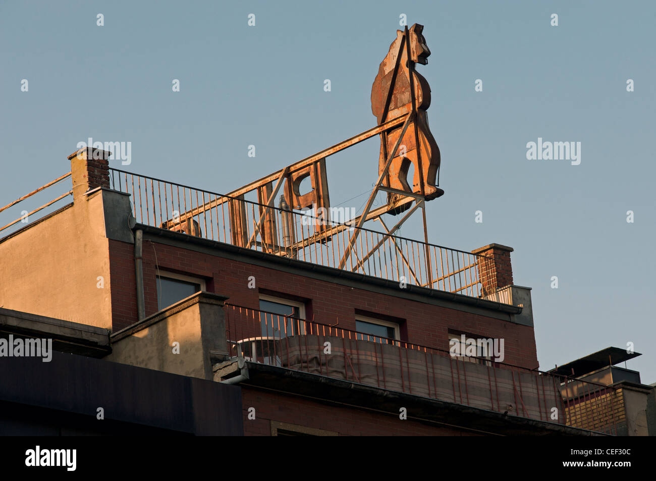 Life size figure of a bear used in advertising on the rooftop of an apartment block, Aachen, Germany. Stock Photo