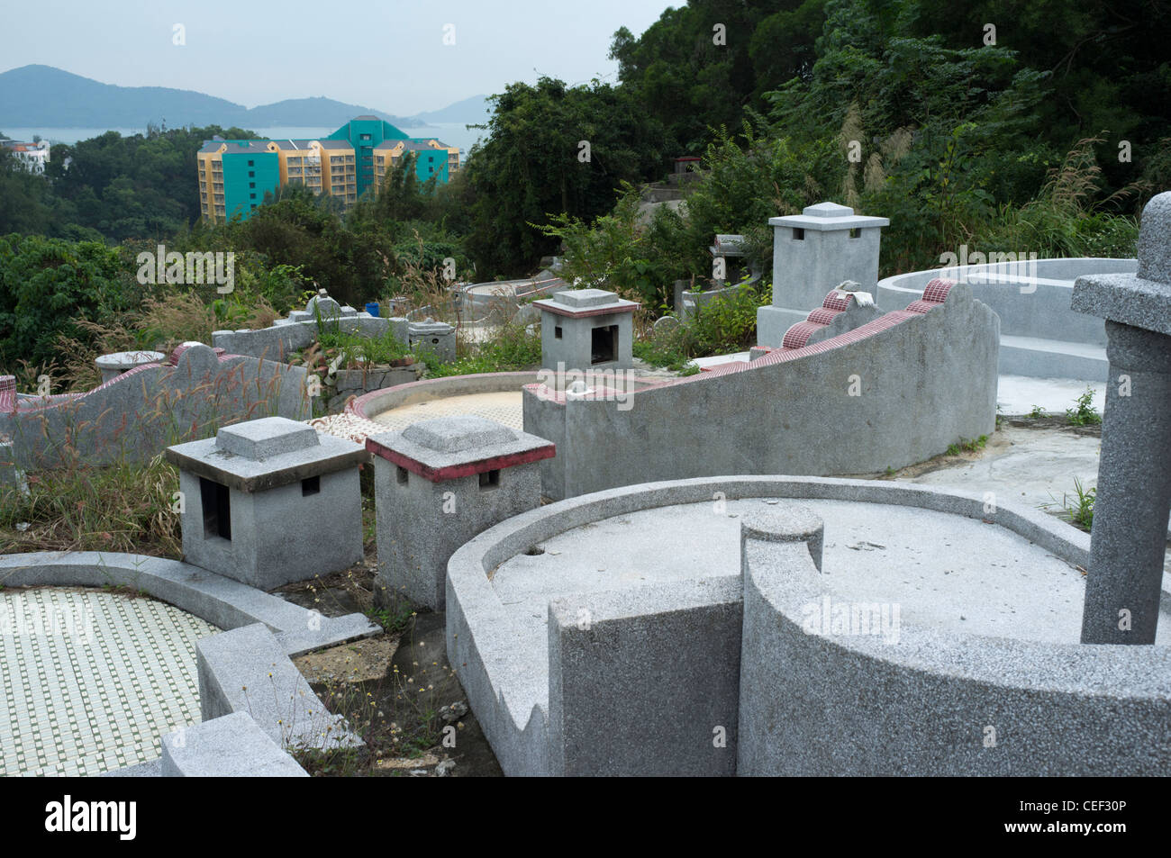 dh PENG CHAU ISLAND HONG KONG Hillside Chinese graves overlooking community new flats family