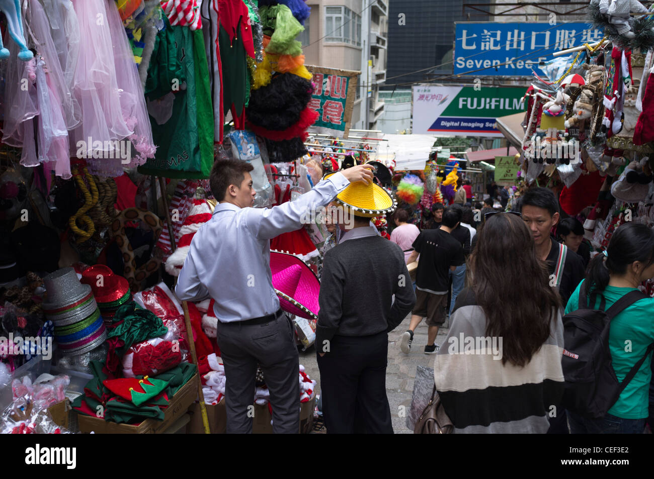 dh Pottinger Street CENTRAL DISTRICT HONG KONG Chinese market stalls men fancy dress stall alley busy people hat lane asia crowd Stock Photo