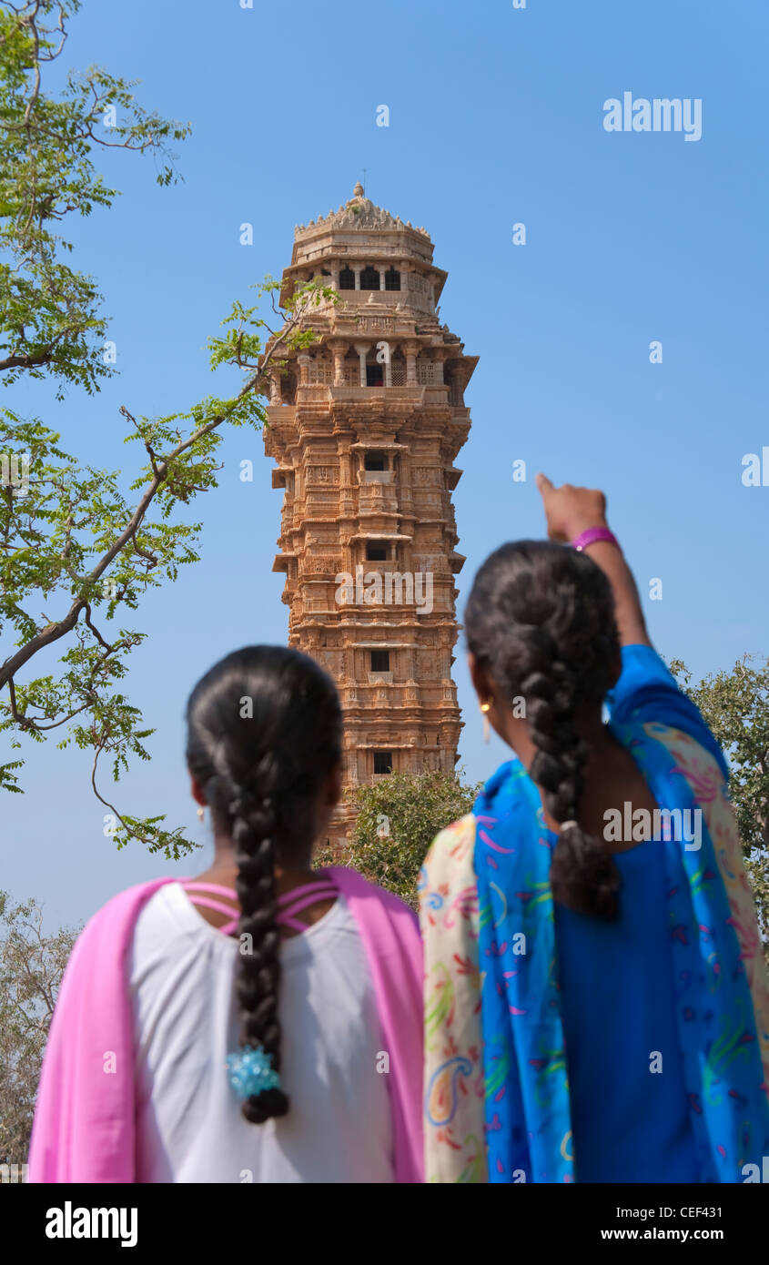 Indian girls with Victoria Tower in Chittorgarh Fort, Rajasthan, India Stock Photo