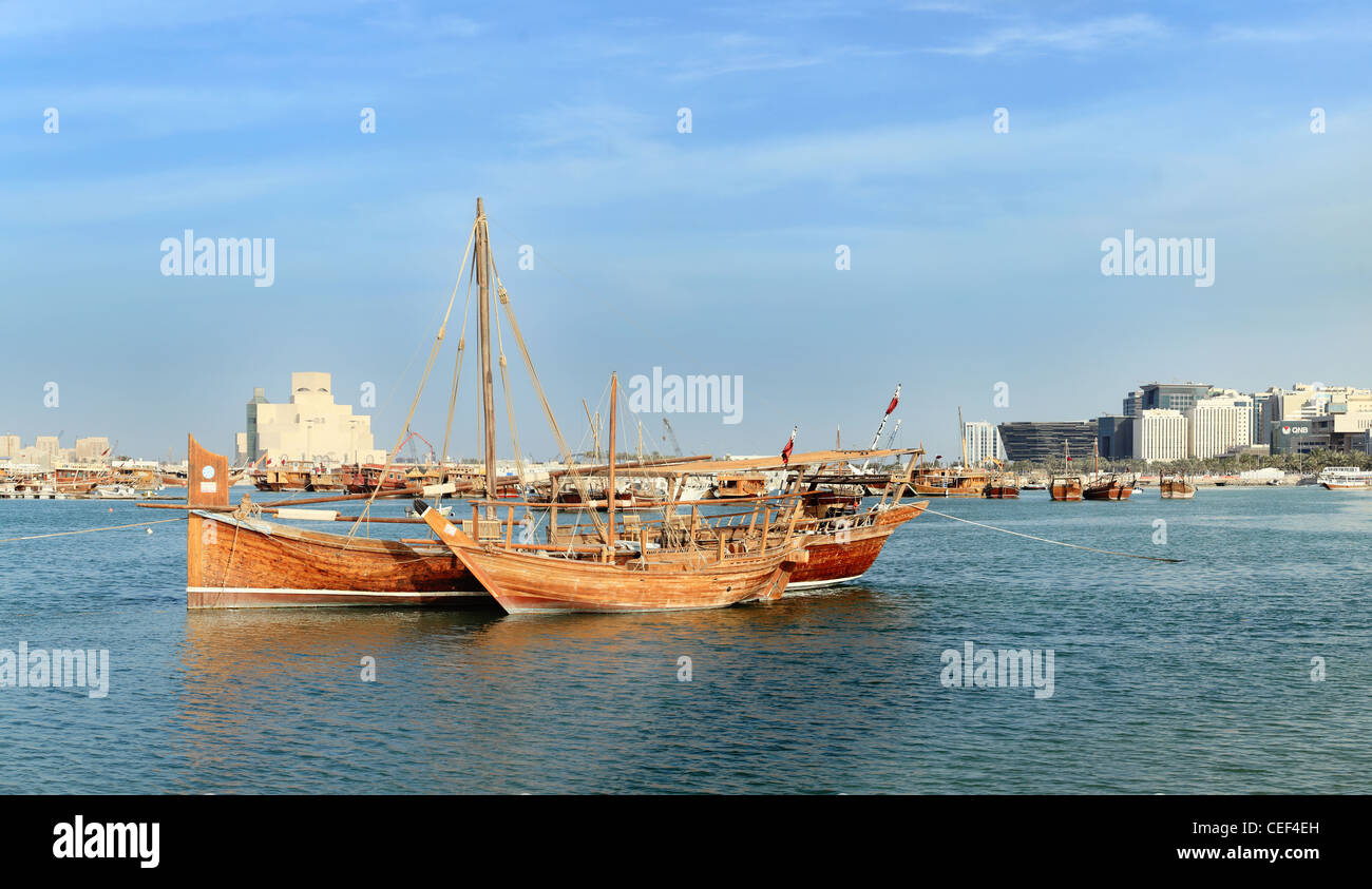 A jalibut dhow, with its distinctive vertical prow, in front of the Museum of Islamic Art in Doha, Qatar, Arabia. Stock Photo