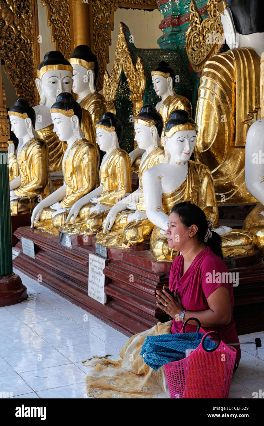 woman pray praying meditate meditating buddhist statues shrine buddhism