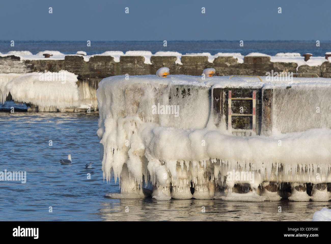 Frozen piers on the Baltic Sea, in Niechorze, Poland. Stock Photo