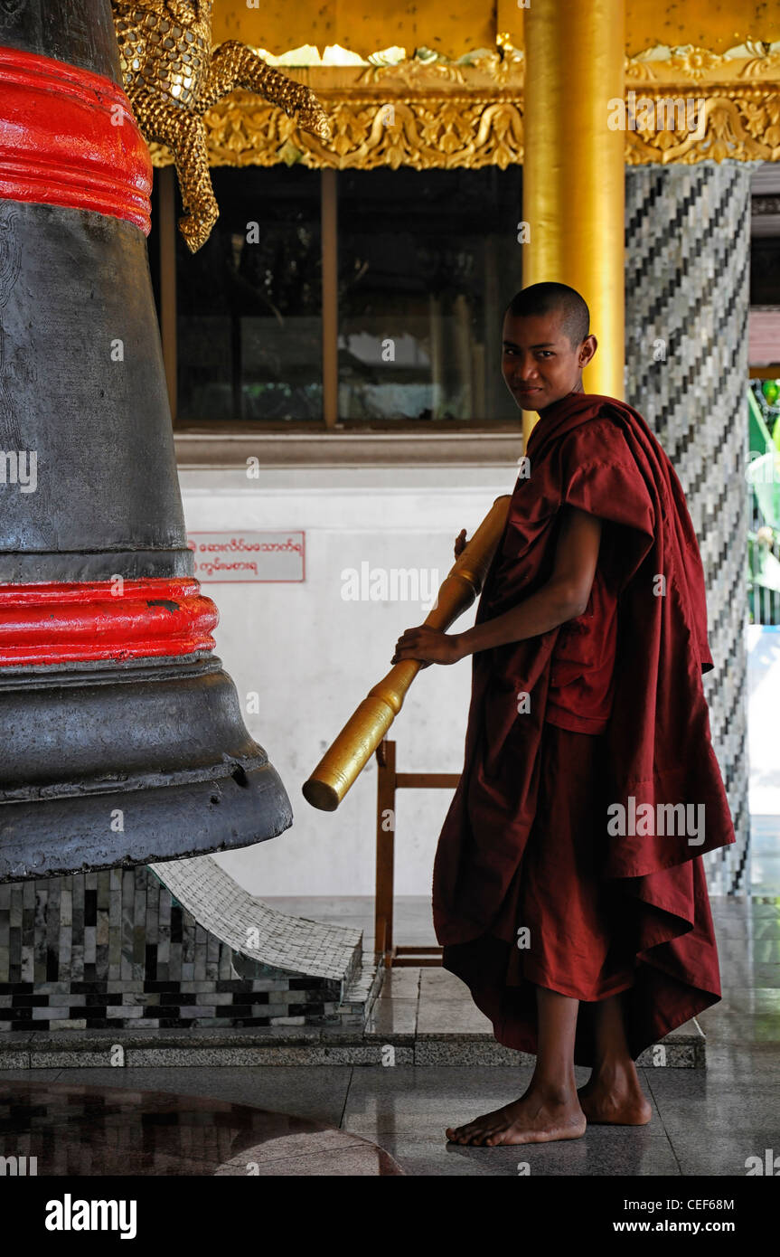 red robed buddhist monk ring ringing bell meditate meditation Shwedagon