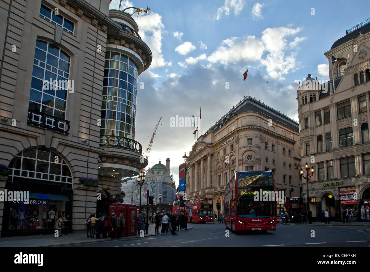 London Piccadilly with London buses and Telephone boxes, busy junction with bus bound for Waterloo. Stock Photo