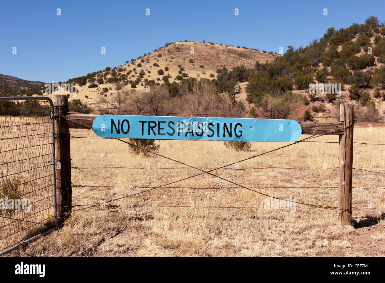 Blue no trespassing sign, rural New Mexico. Stock Photo