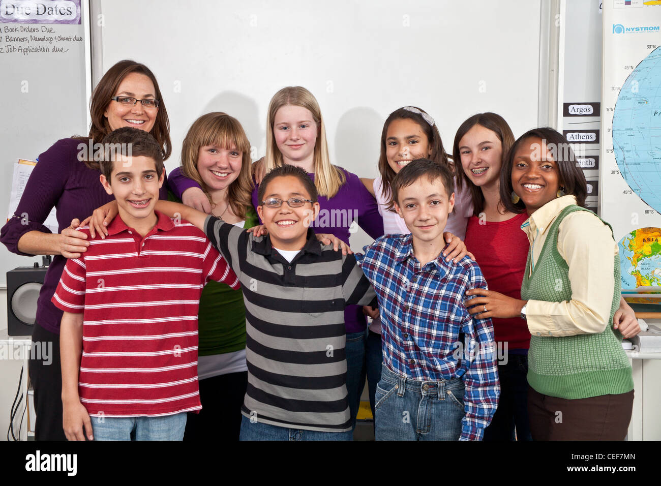school class interracial Multi Ethnically diverse kids hang hanging out Group students teacher teachers aide smiling camera. Different heights Stock Photo