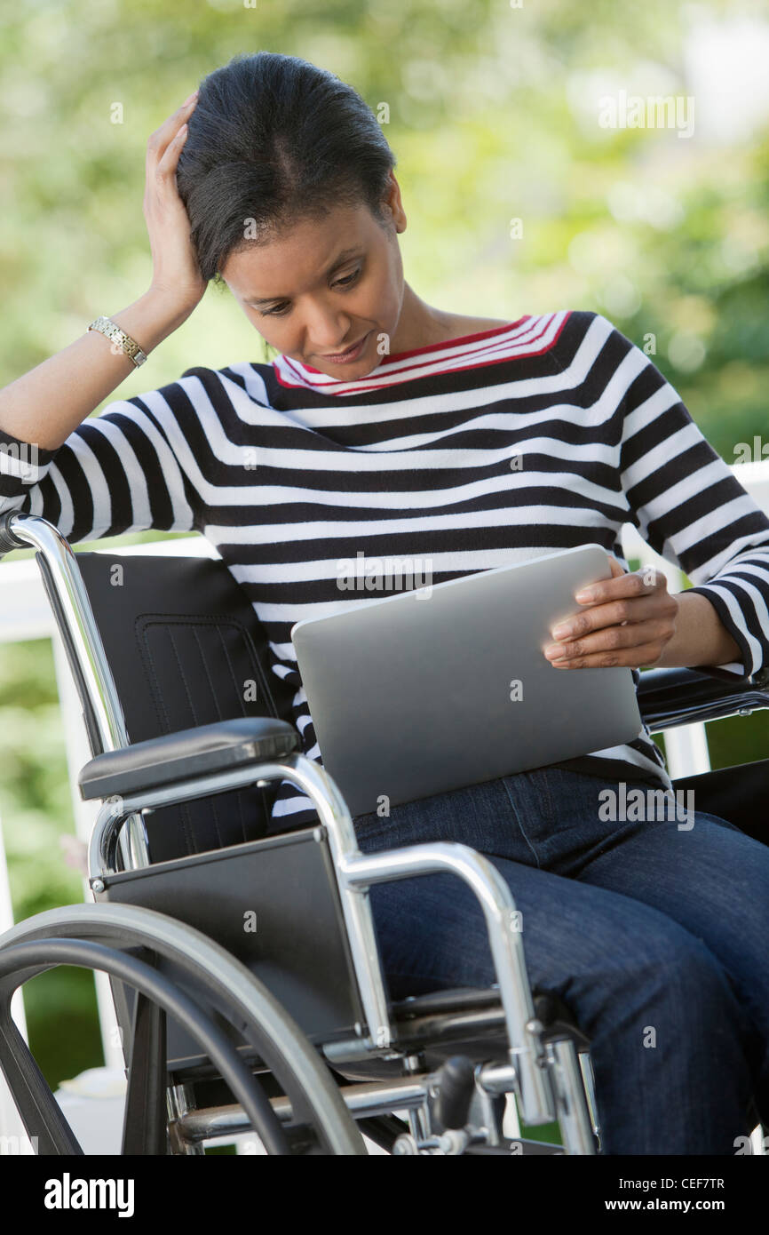 Disabled woman with Digital Tablet Stock Photo