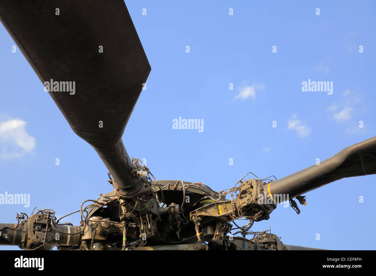 Main rotor blades and rotor head against blue sky, military helicopter Stock Photo