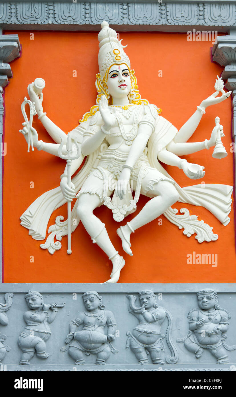 Hindu Goddess with Many Arms Statue on Wall of Sri Senpaga Vinayagar Temple Stock Photo