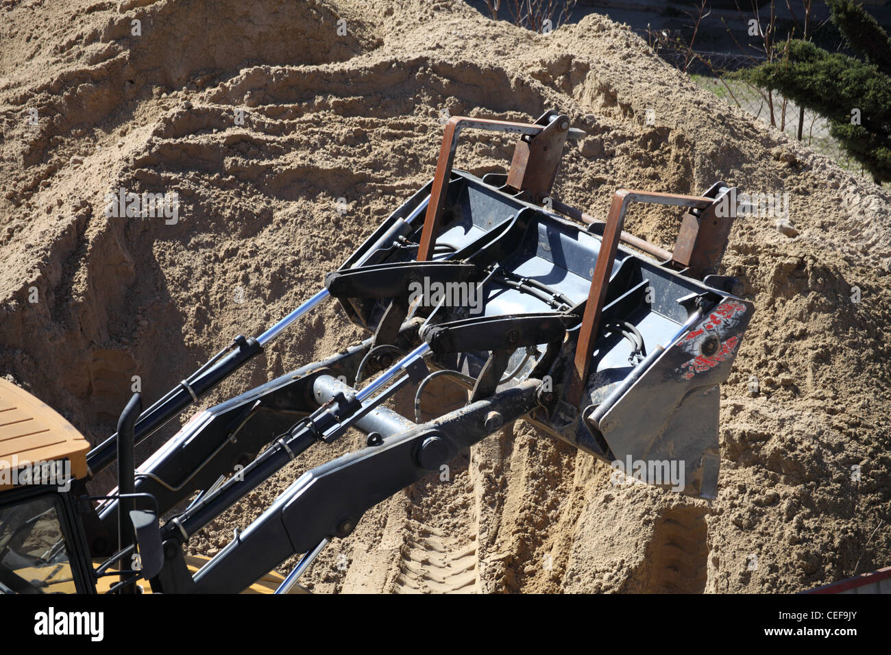 Yellow excavator on the construction site Stock Photo - Alamy