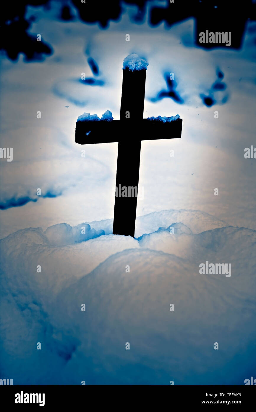Wooden cross on a grave with snow Stock Photo