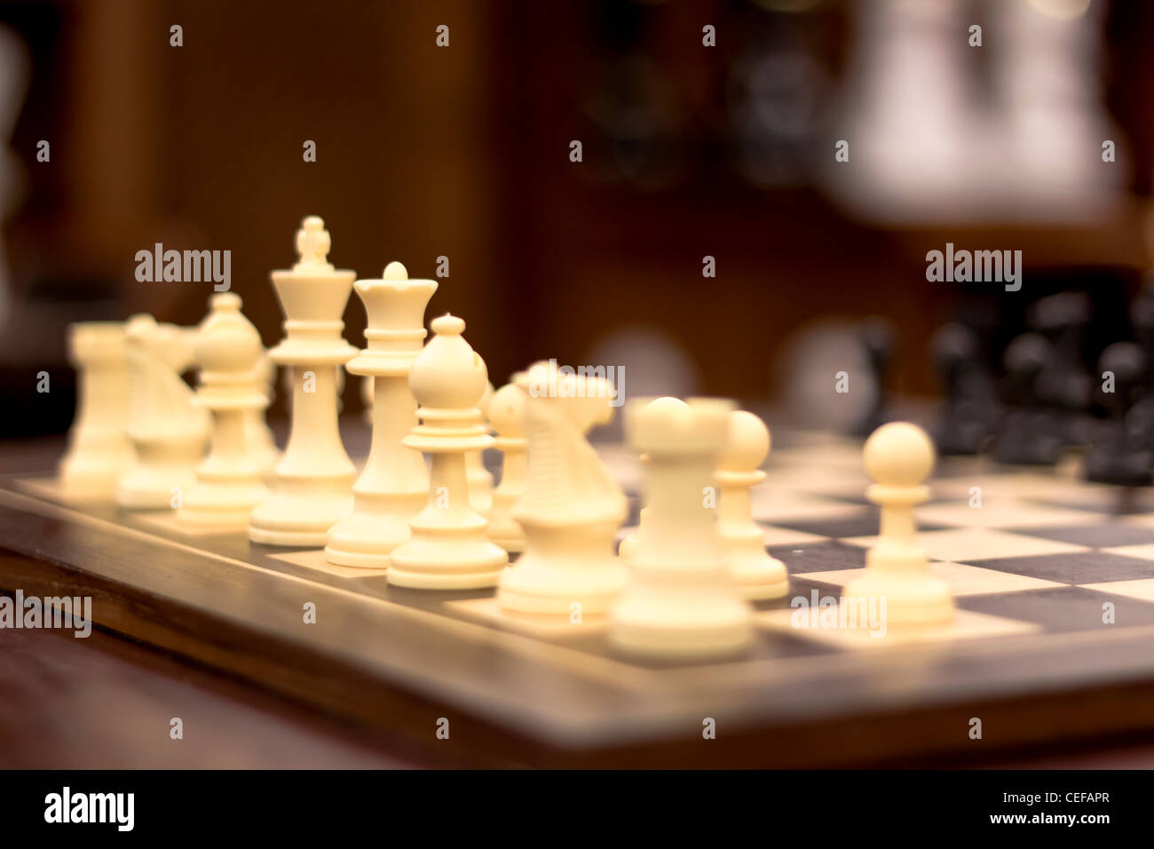 Image of a chess board, with focus on the king and queen of the white pieces. Stock Photo