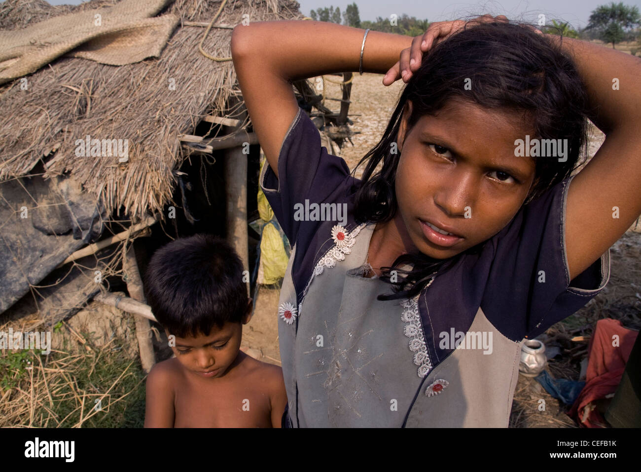 Children have been forced to relocate due to sea level rise. They are pictured in front of their new home. Stock Photo