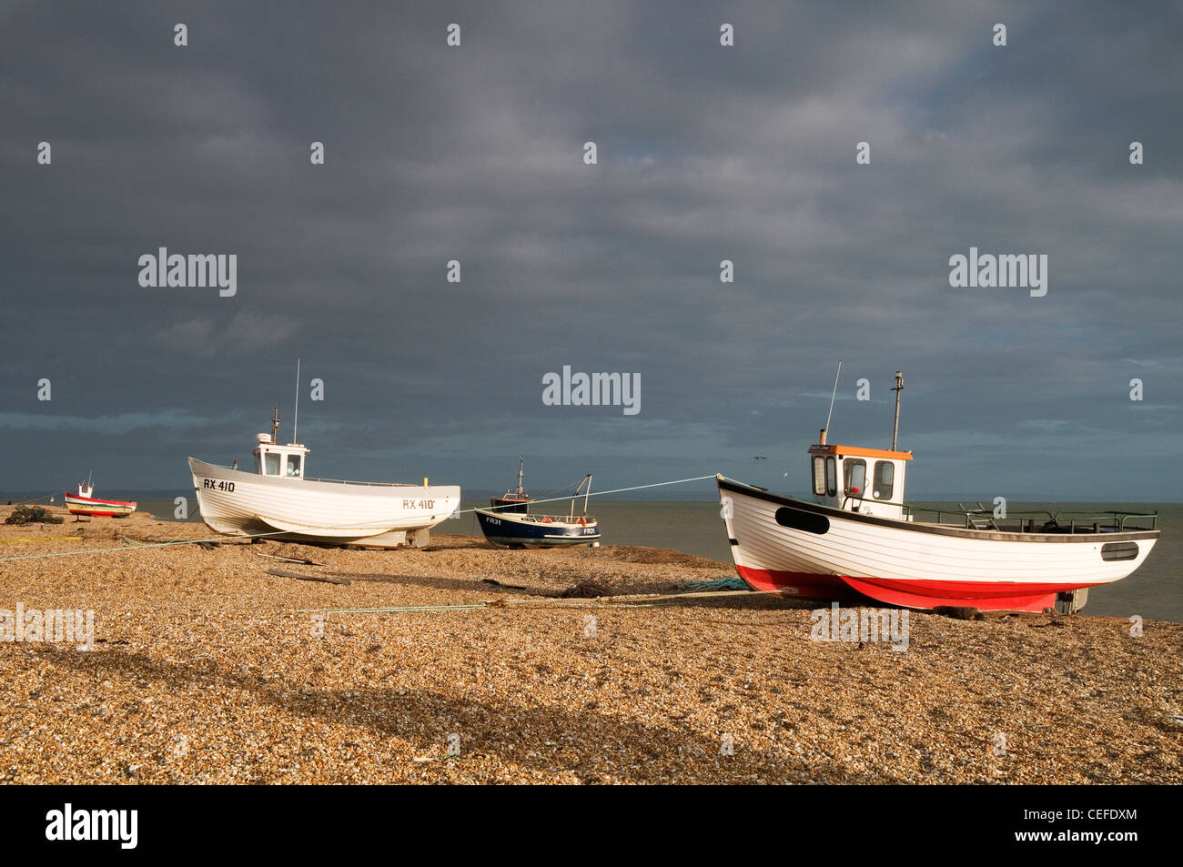 Fishing boats beached on the shingle at Dungeness Kent England UK Stock ...