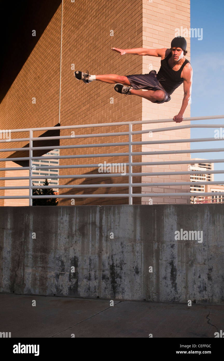 Athlete jumping over urban wall Stock Photo Alamy