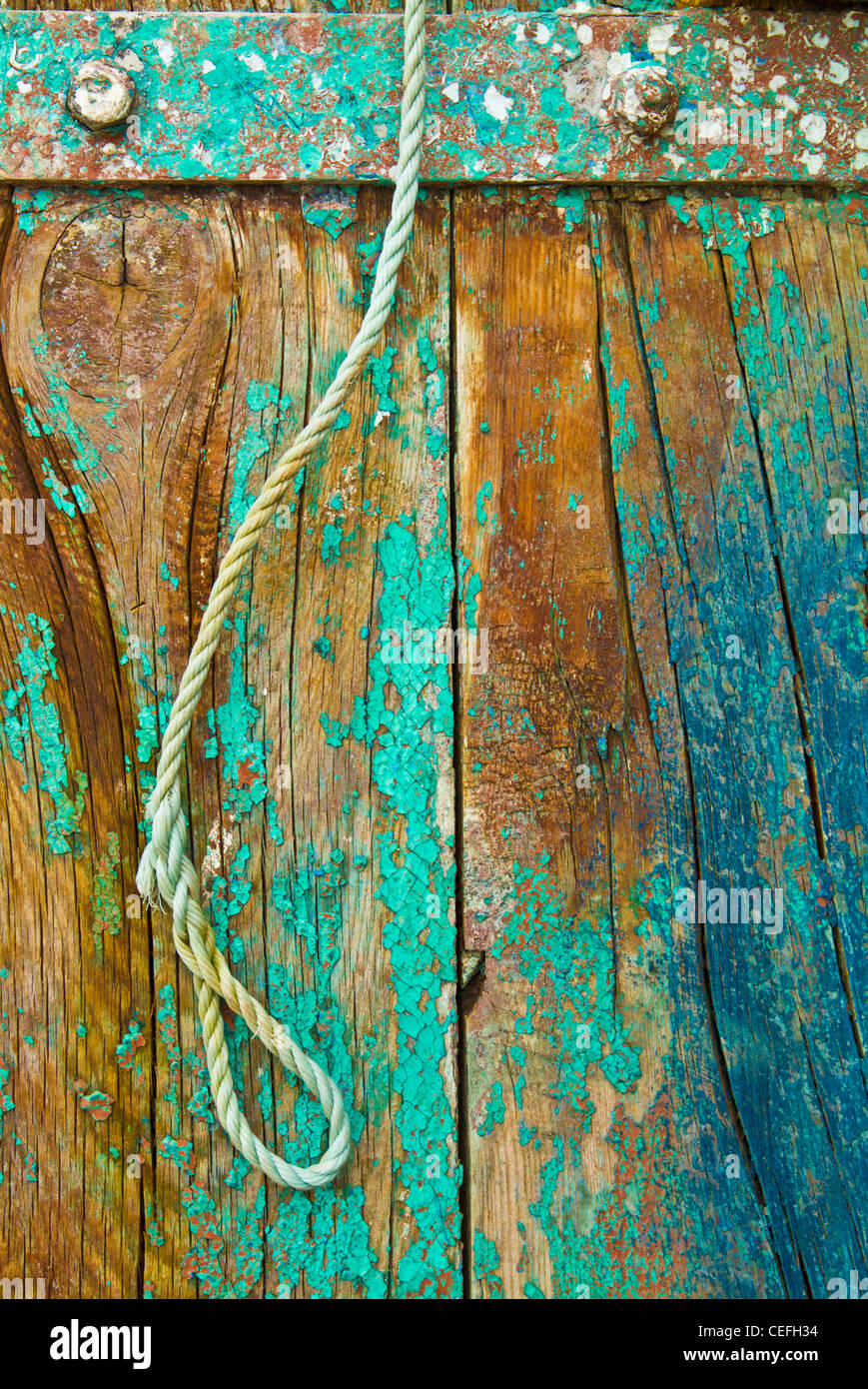 Flaking paint and rope noose on old wood Stock Photo