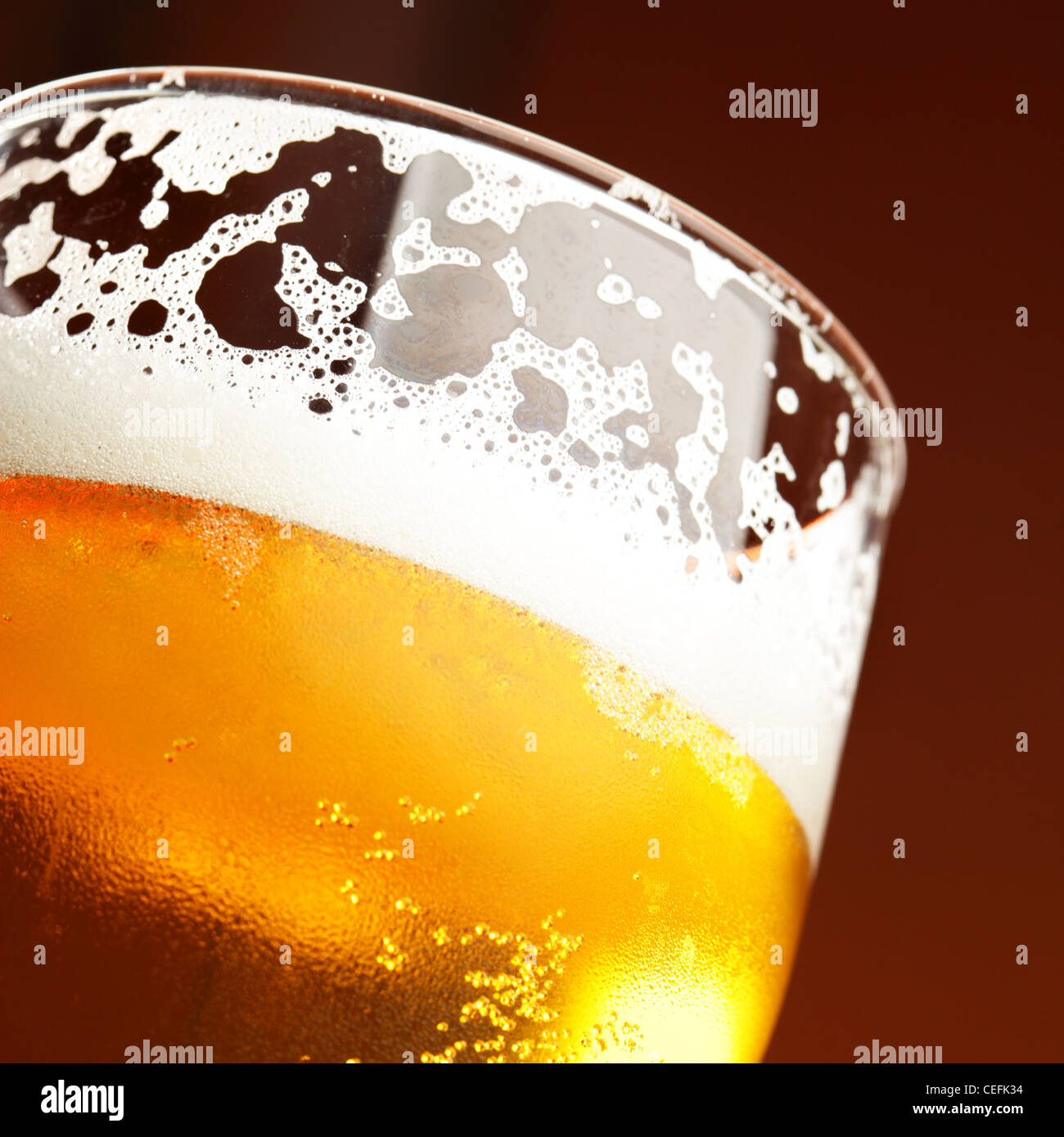 Close up of beer glass with froth Stock Photo