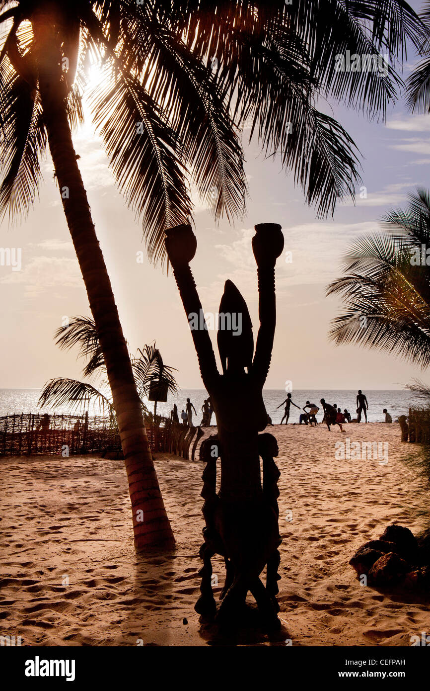 Traditional African sculpture faces the Cogotiers beach in front of the Tama Lodge, a luxury hotel in Mbour, Senegal. Stock Photo