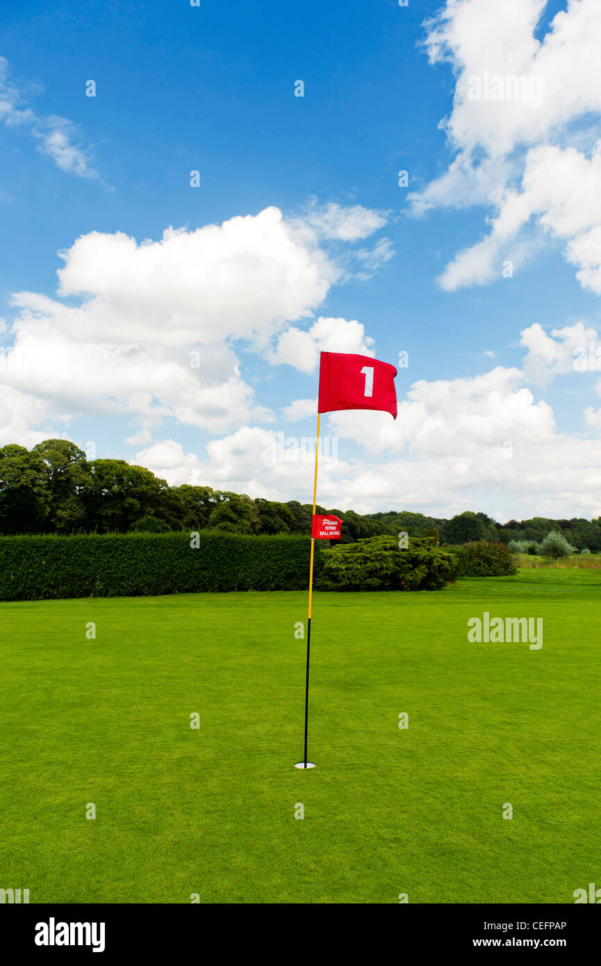 red flag of hole number One on golf course Stock Photo