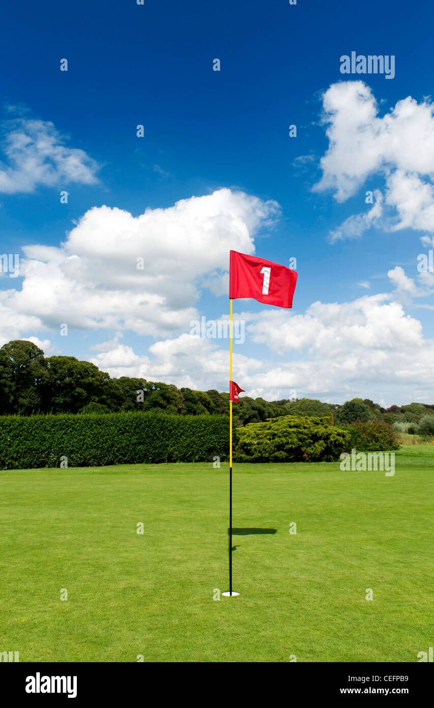 red flag of hole number One on golf course Stock Photo