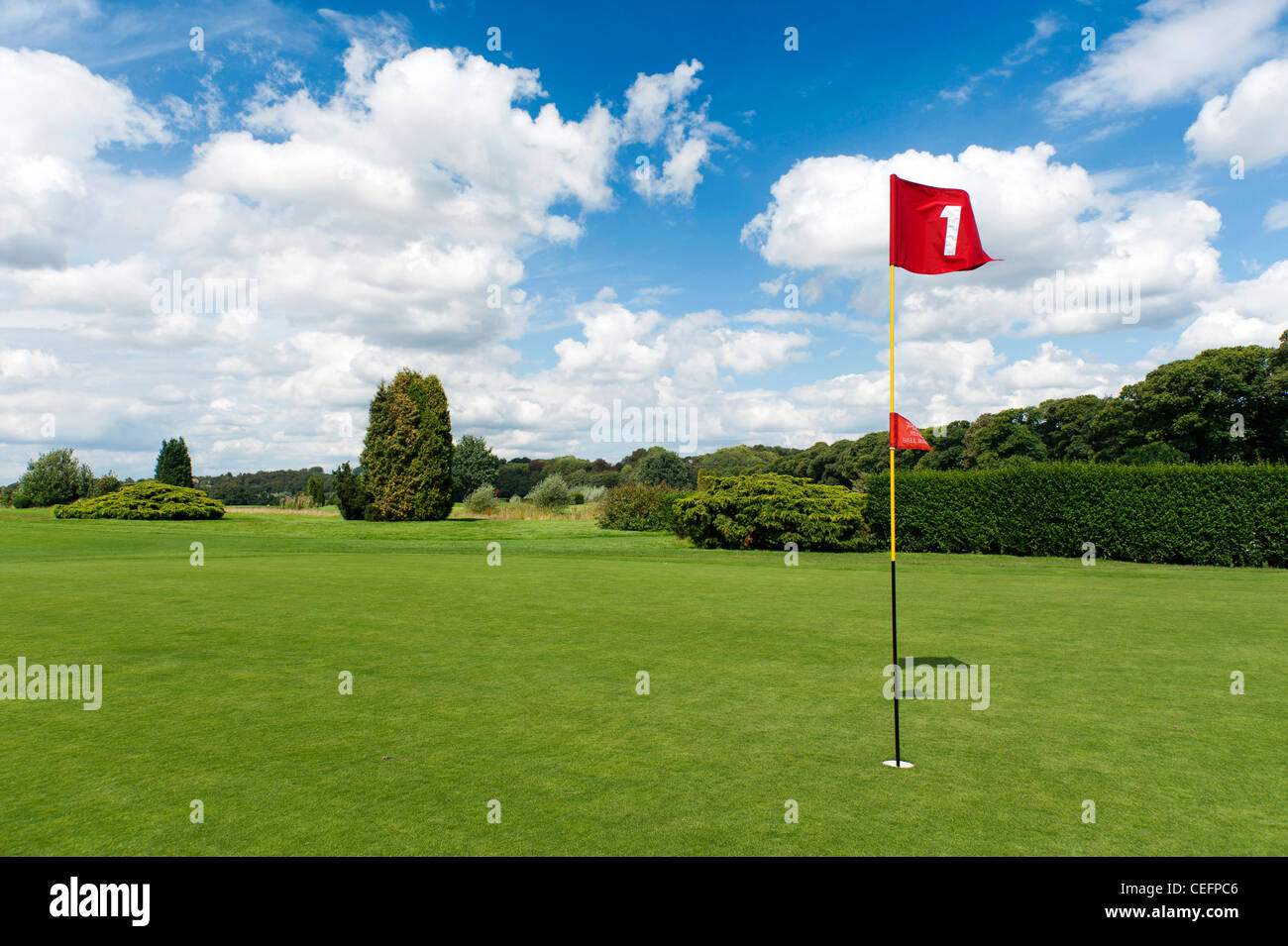 red flag of hole number One on golf course Stock Photo - Alamy