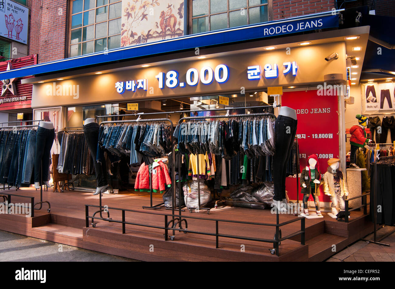 Clothes shop near Hongik University, Seoul, Korea. The sign says all the  jeans are at 18000 won (approx 10.00 sterling pounds Stock Photo - Alamy