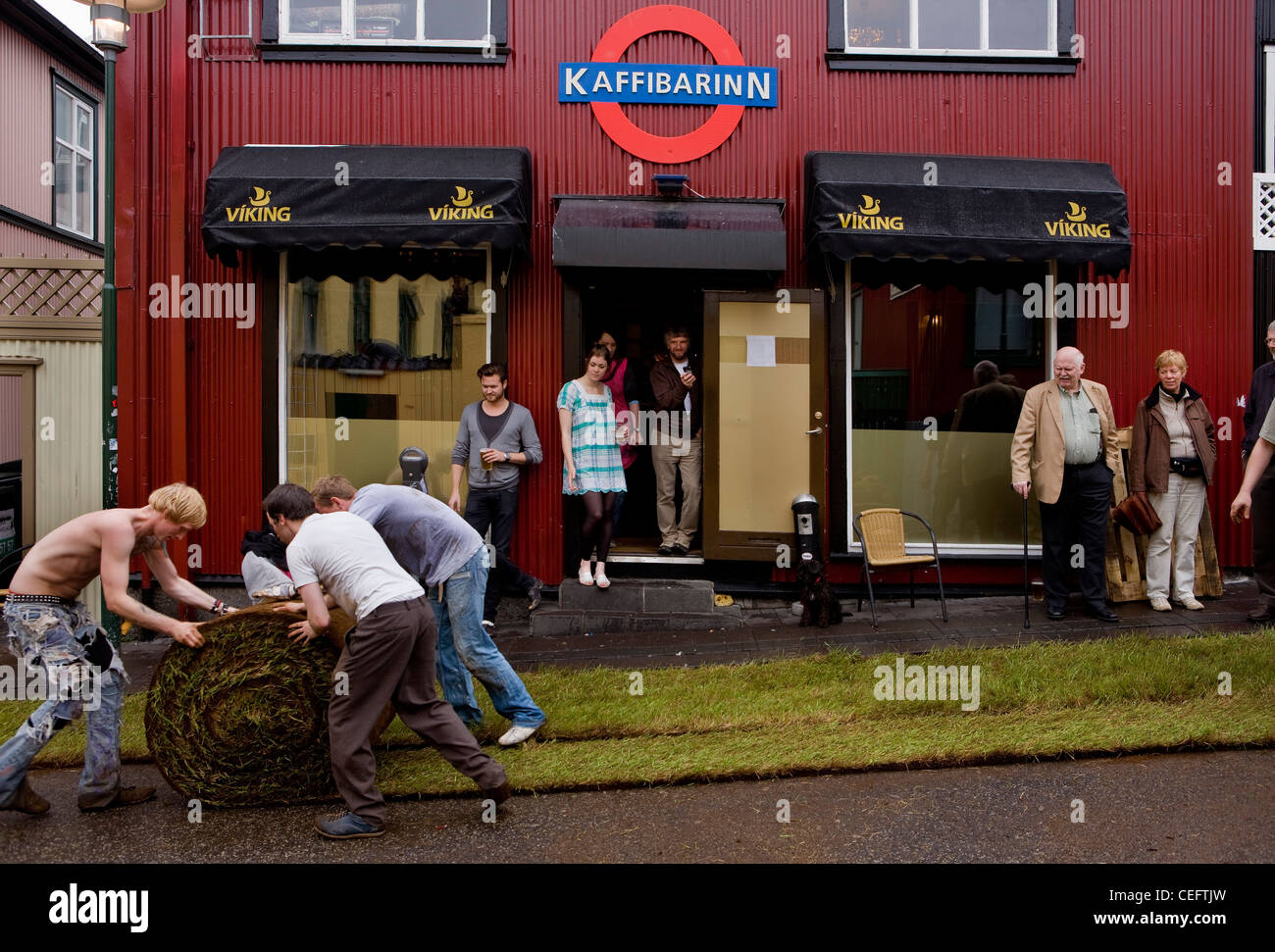 Laying turf on the street for a party on Reykjavik Culture Night, one of the most popular events in Icelandic art life. Stock Photo