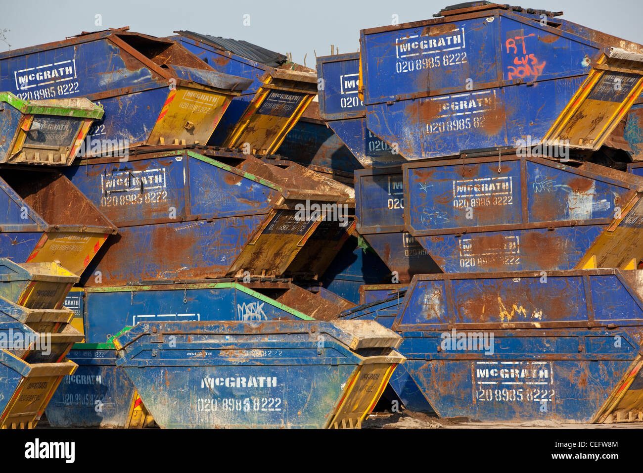 Building refuse skips stacked upon one another, Hackney Wick, East London, UK Stock Photo