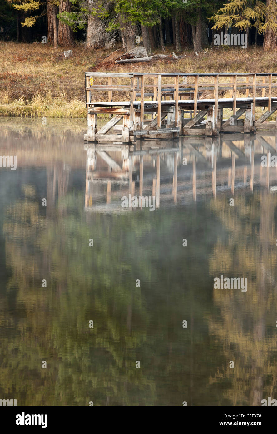 Bridge reflection in the Clearwater River in Seeley Lake, Montana Stock
