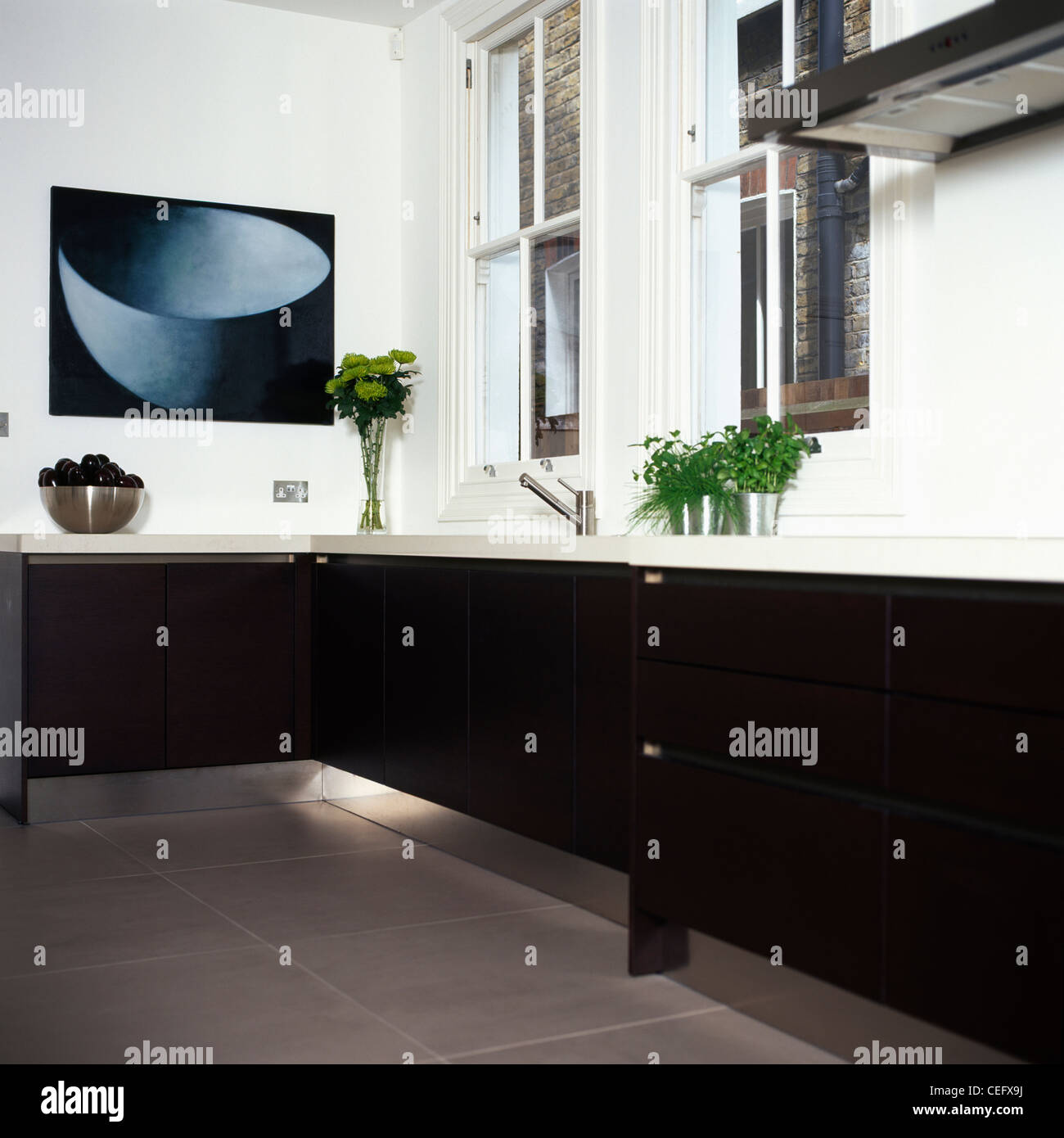 Picture above worktop in modern white kitchen with stainless steel kick