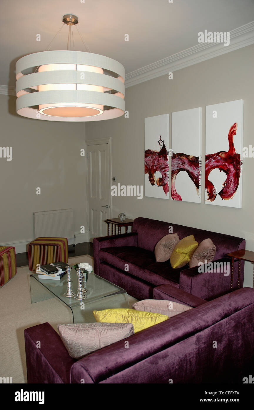 Circular Modern Ceiling Light Above Purple Silk Sofas In
