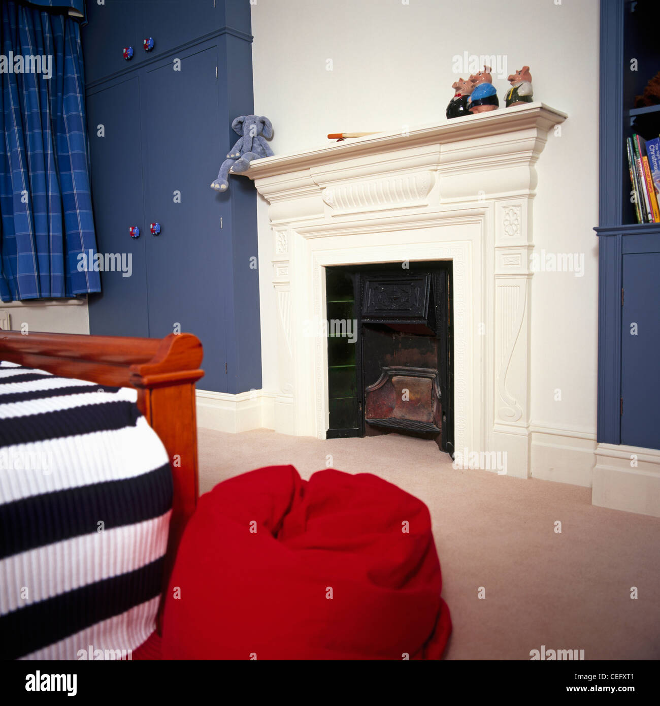 Red Beanbag Beside Bed With Striped Knitted Bed Cover In Child S