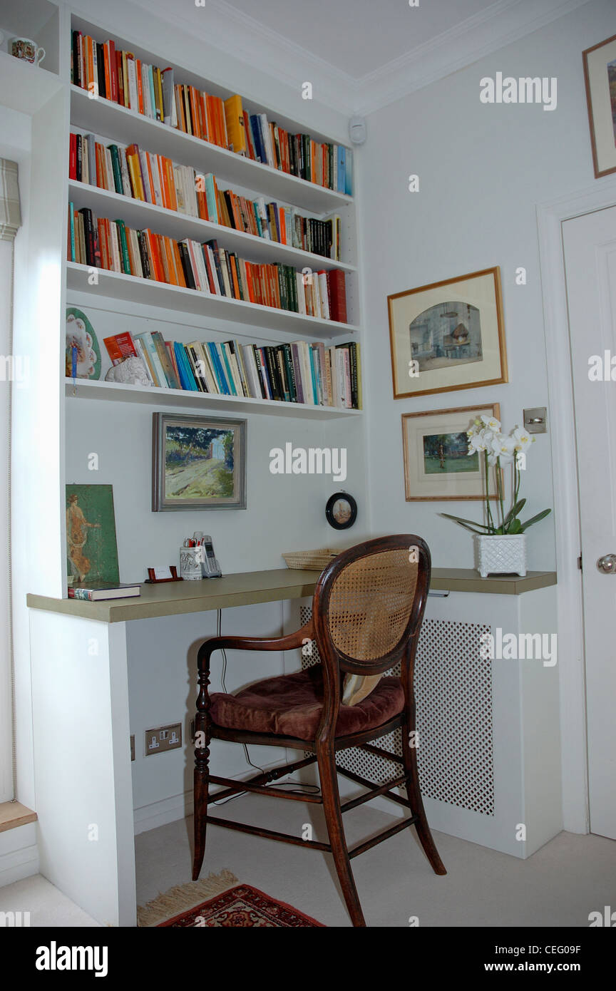 Antique Chair At Fitted Desk Below Bookshelves In Study Corner Of