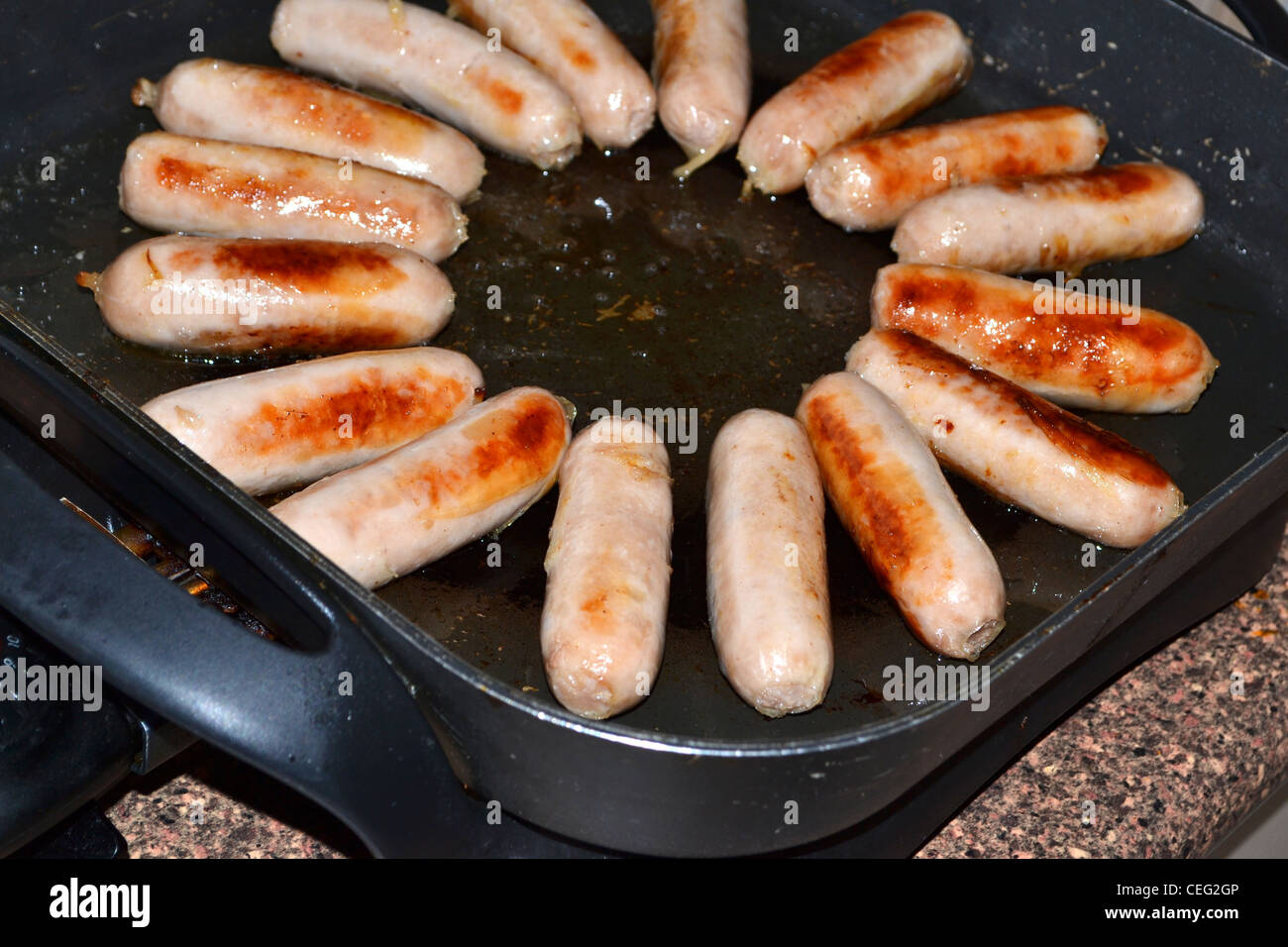 sausages cooking in fry pan Stock Photo Alamy