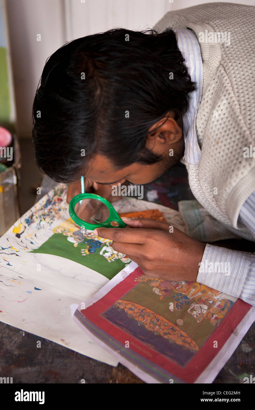 India, Uttar Pradesh, Varanasi, artist using magnifier to paint