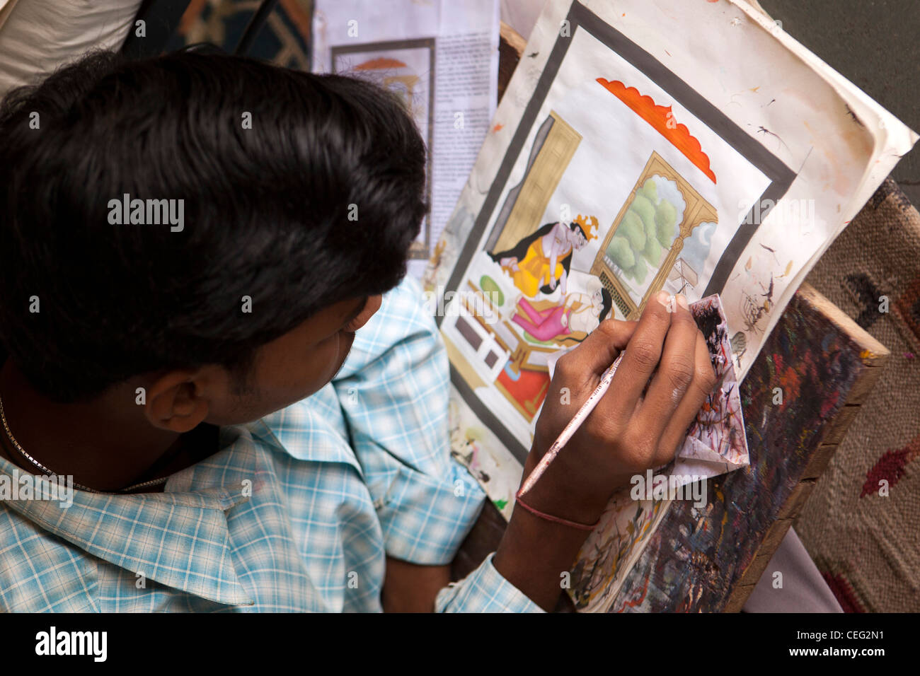 India, Uttar Pradesh, Varanasi, hands of artist painting detailed