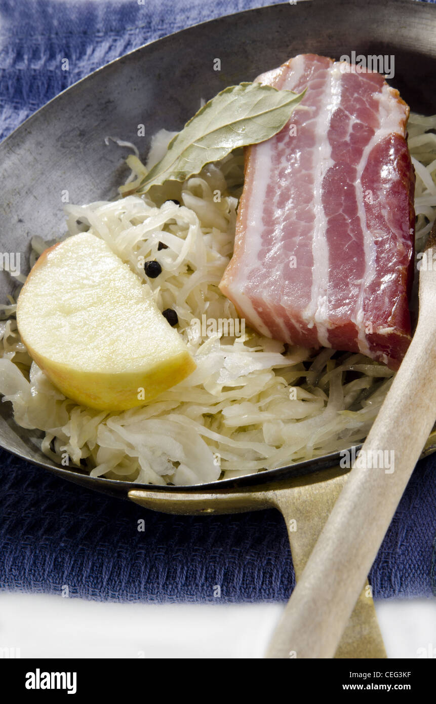 Sauerkraut with bacon and apple in a pan Stock Photo