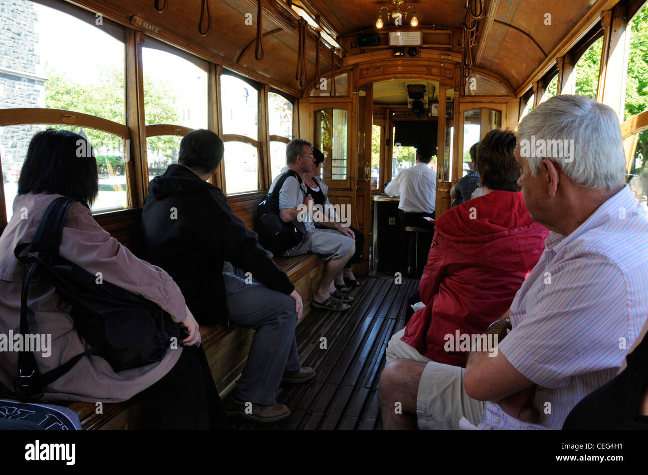 Tourists enjoying a ride on one of the vintage trams of Christchurch Tramways in Christchurch, New Zealand. Stock Photo