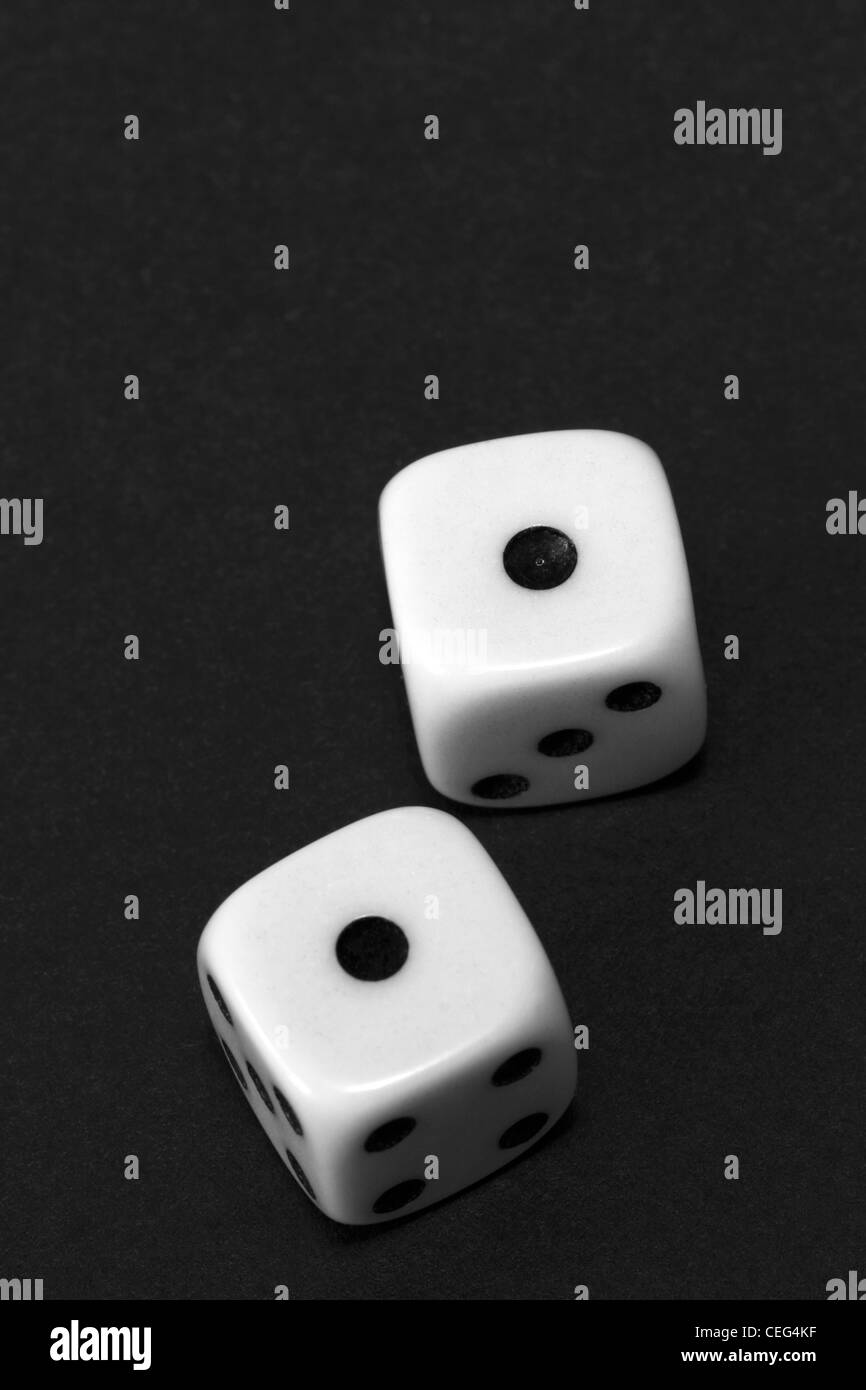 A black and white image of snake eyes rolled on a pair of dice Stock Photo