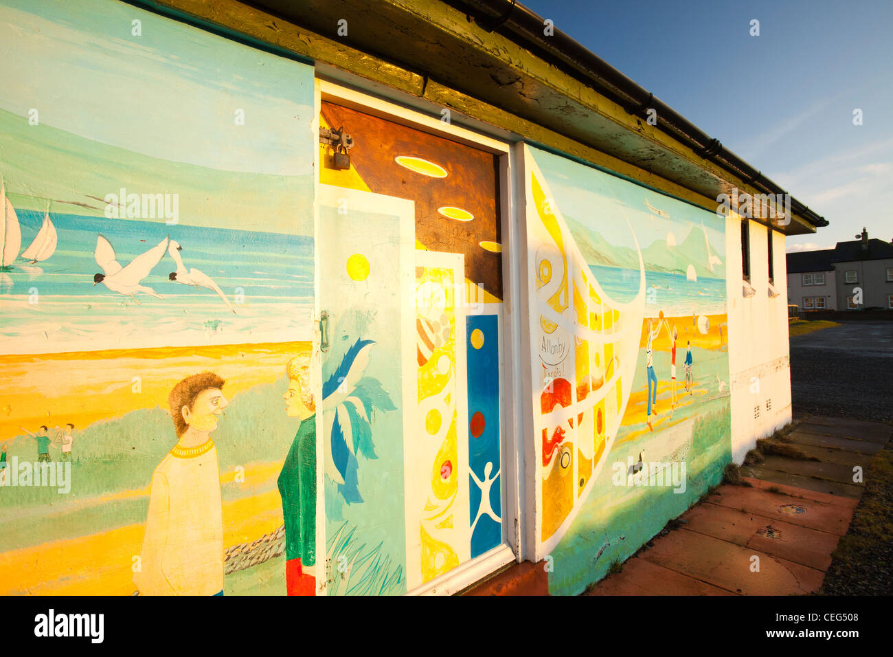 A mural on the seafront in Allonby on the Solway Coast, Cumbria, UK in warm evening light at sunset. Stock Photo