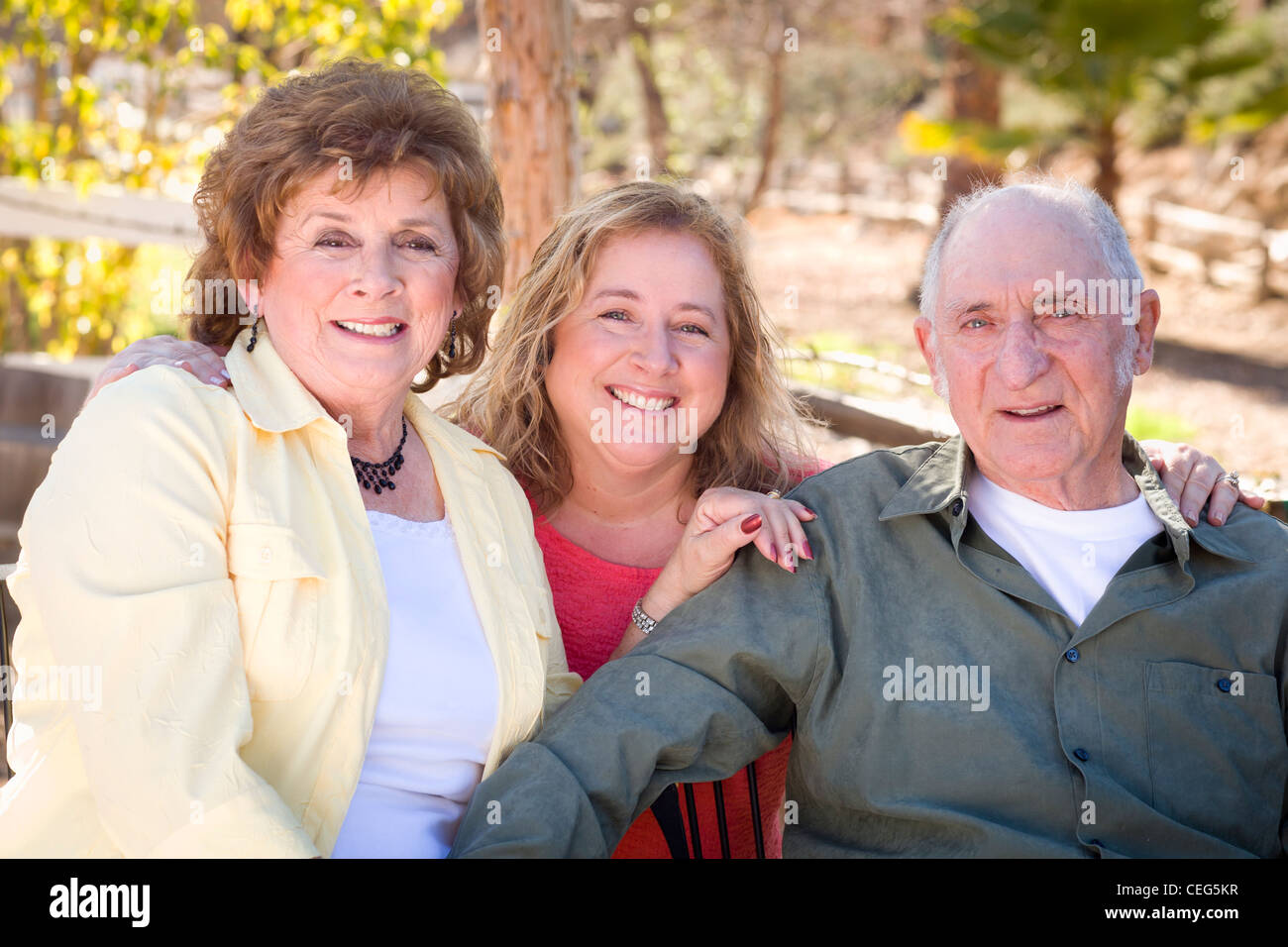 Portrait of Senior Couple with Daughter in the Park. Stock Photo