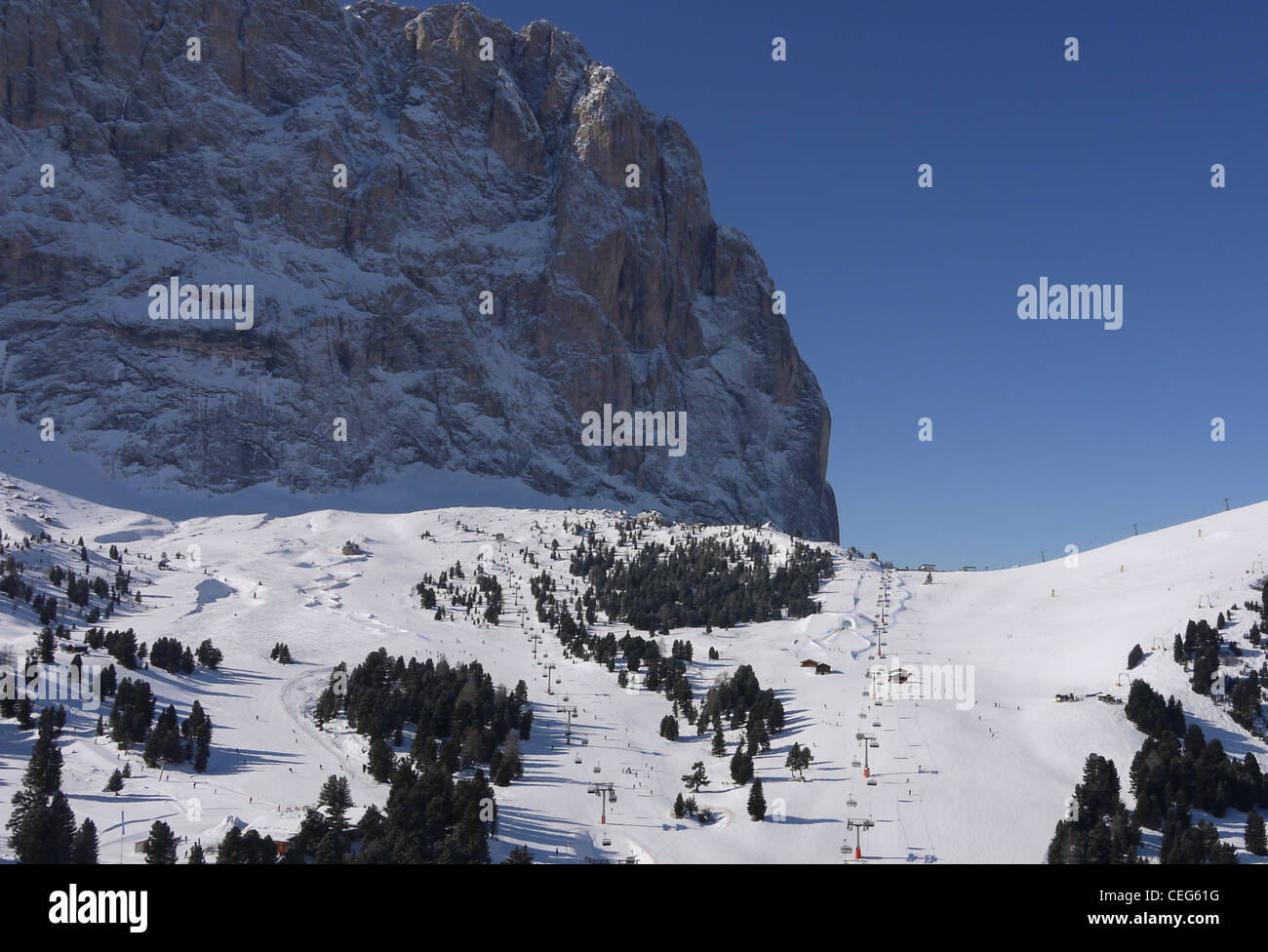 The ski slopes of Selva Val Gardena with the massive hulk of the Lang Kofel or Sasso Lungo on the Sellaronda ski circuit Stock Photo