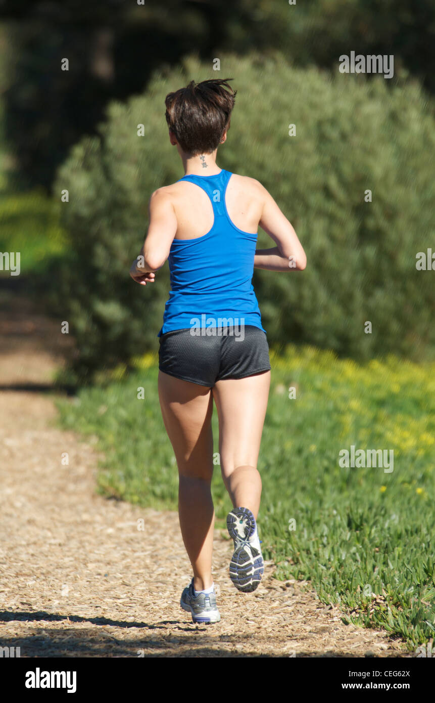 A woman running on a path. Stock Photo