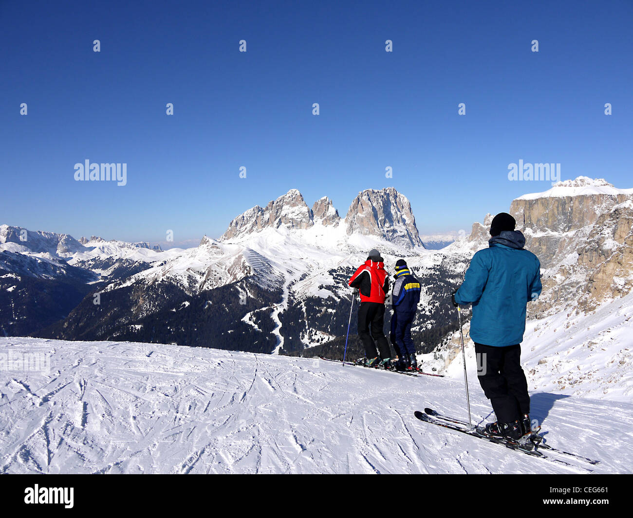 Skiers at the top of the Belvedere run between the resorts of Canazei and Val Gardena Wolkenstein. Stock Photo