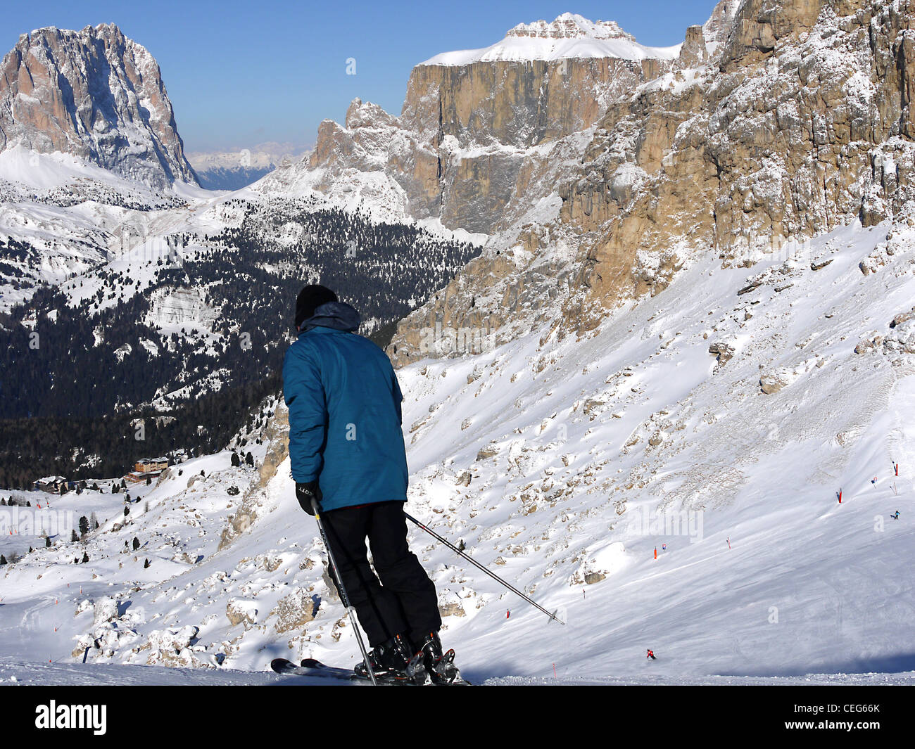 Skier setting of from the top of the Belvedere ski lifts above Canazei with the central group of Sella Ronda mountains ahead Stock Photo